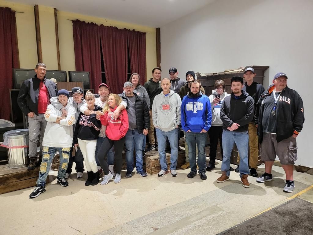 A group of people are posing for a picture in a living room.