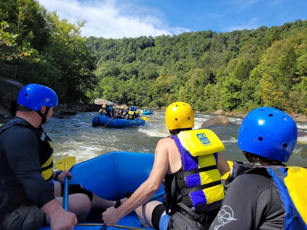 A group of people are riding a raft down a river.