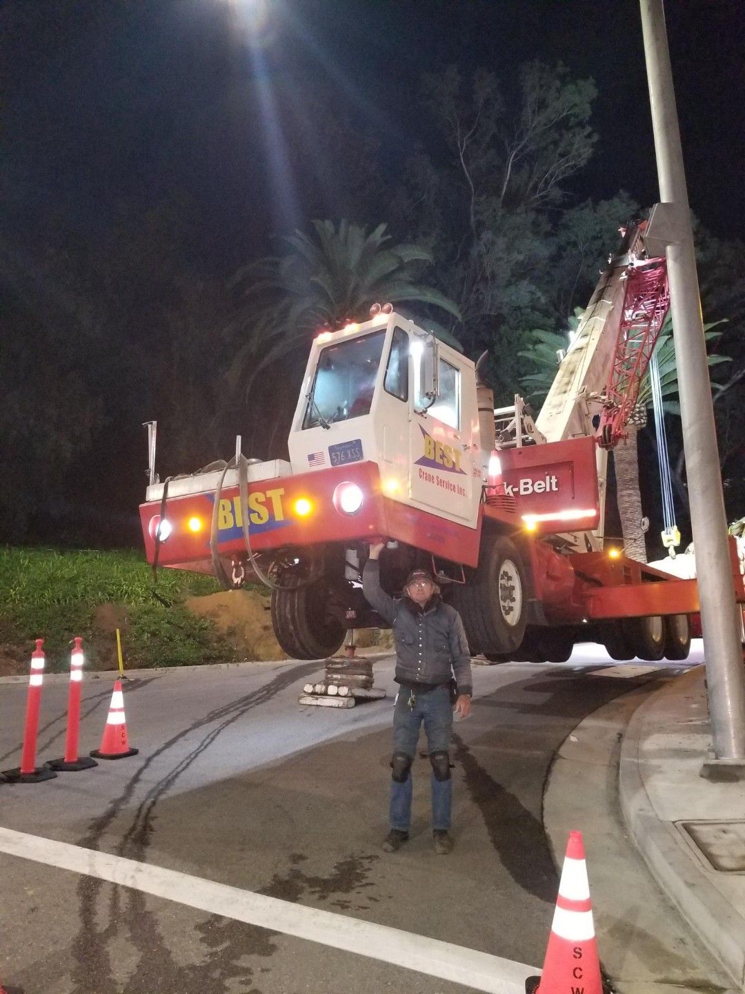 A man is standing in front of a crane - San Diego, CA - Best Crane Service Inc.