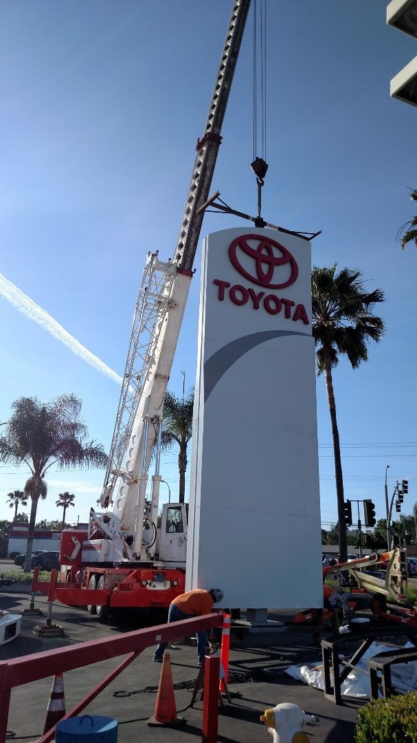 A toyota sign is being lifted by a crane - San Diego, CA - Best Crane Service Inc.