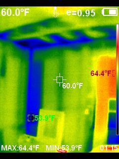 Thermal image showing a room with temperature variations indicated by colors. 