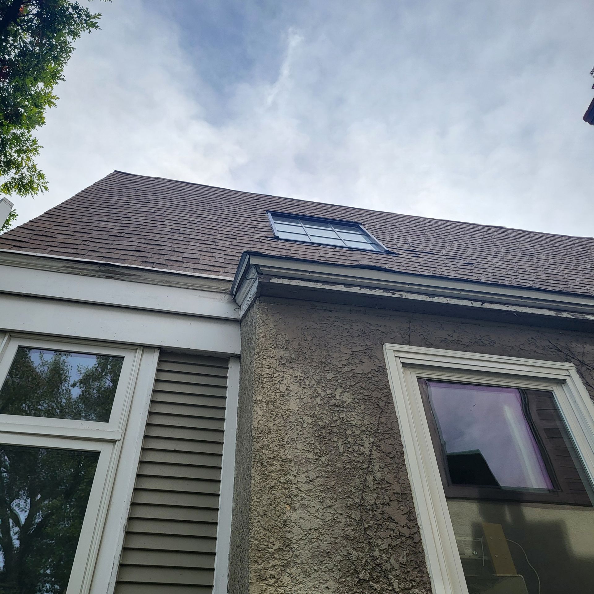 Looking up at the roof of a house with a skylight