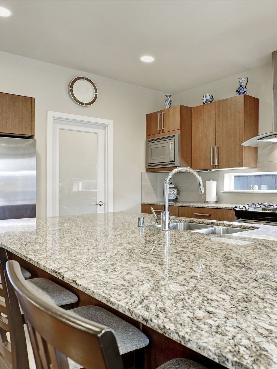 A kitchen with granite counter tops and stainless steel appliances