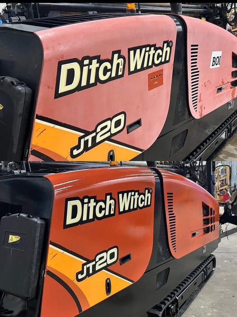 Two ditch witch jt20 tractors are sitting next to each other in a garage.