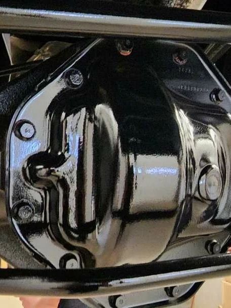 A close up of a black gearbox on a motorcycle