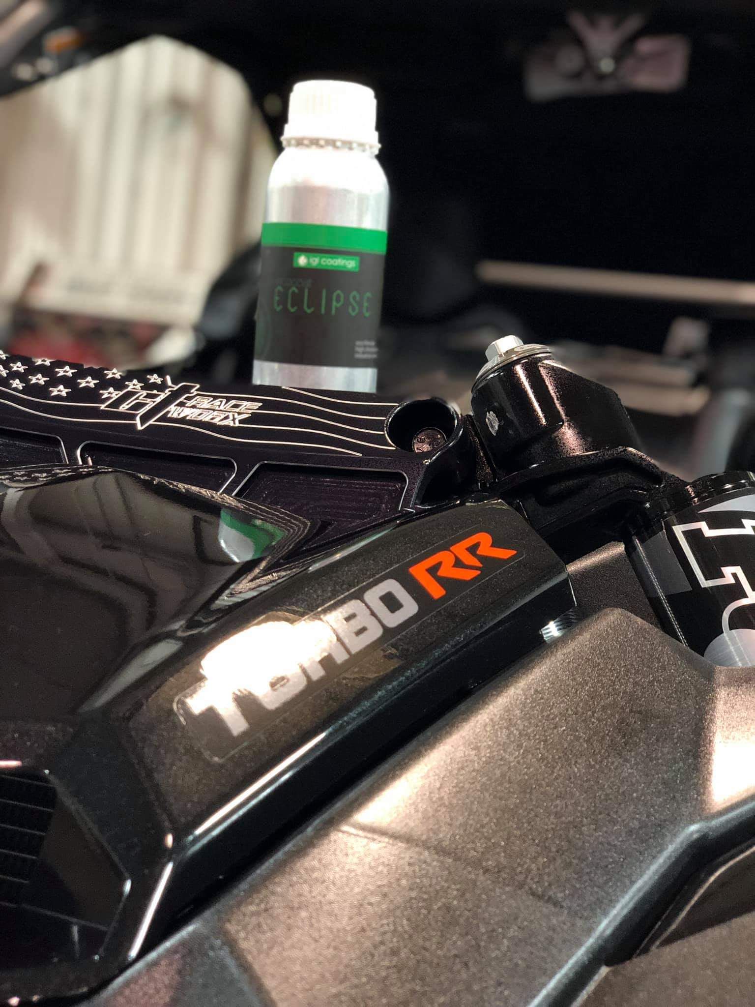 A bottle of eclipse is sitting on the side of a motorcycle.