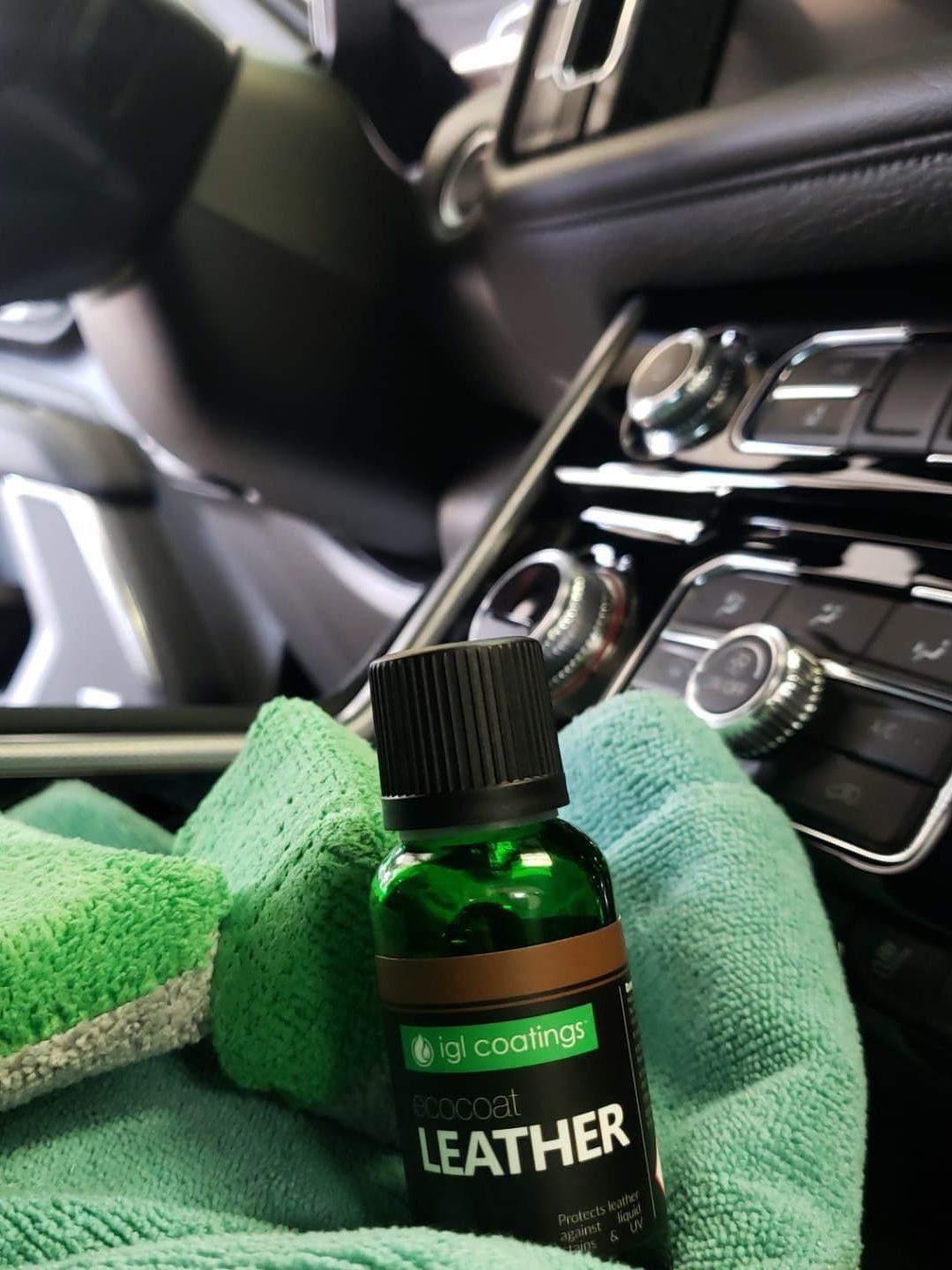 A bottle of leather sitting on top of a green cloth