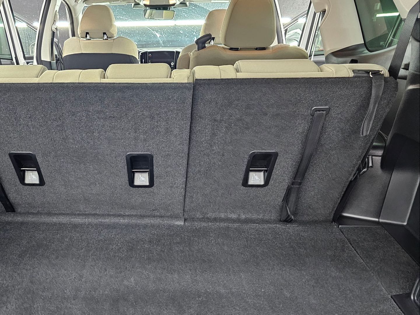 The back seat of a car with the seats folded down.
