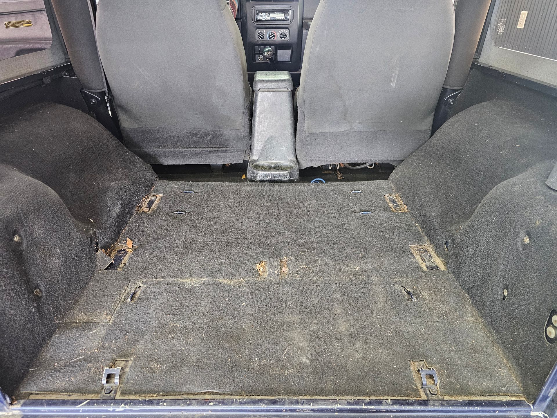 The back of a car with a carpeted floor
