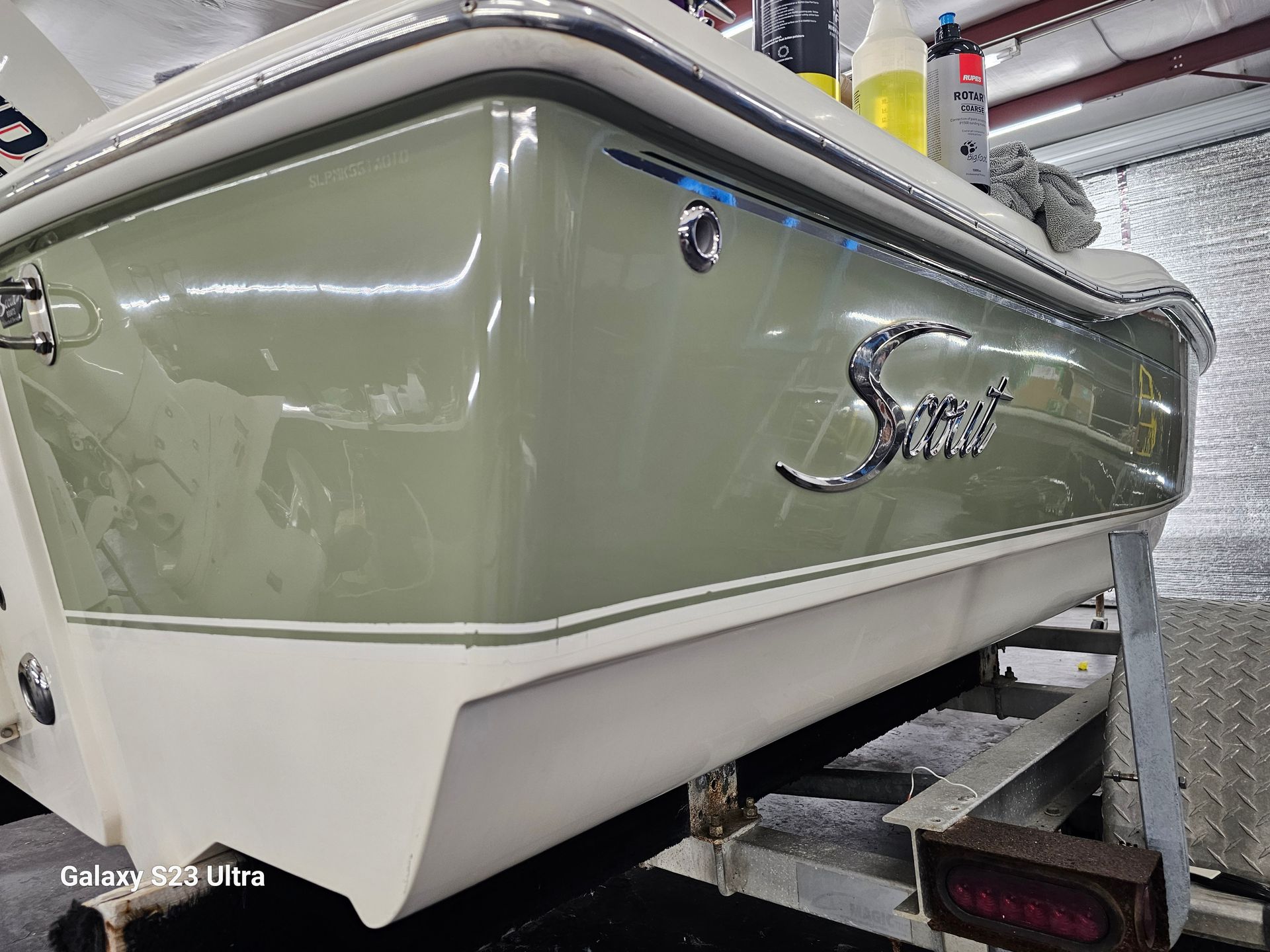A boat is sitting on a trailer in a garage.