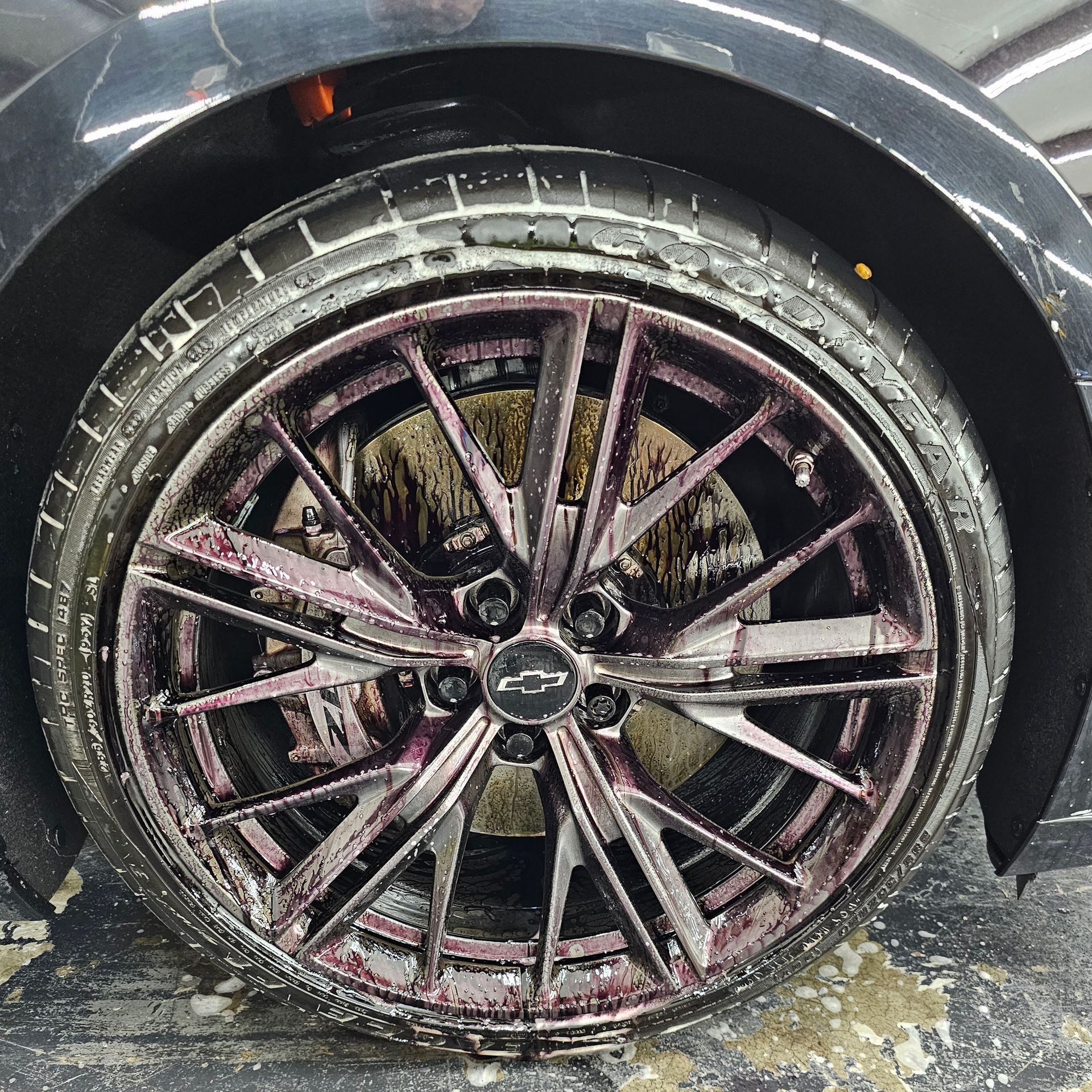 A close up of a dirty tire on a car.