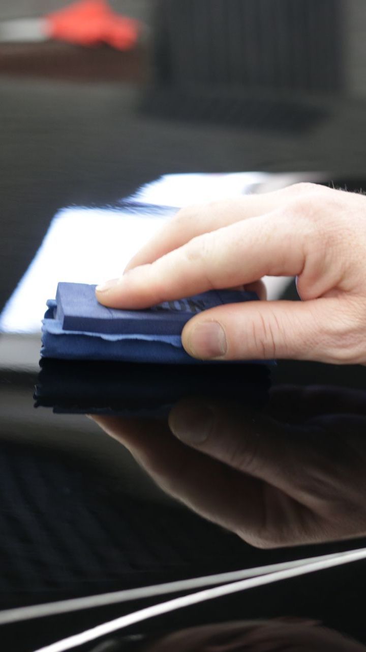 A close up of a person 's hand holding a piece of paper