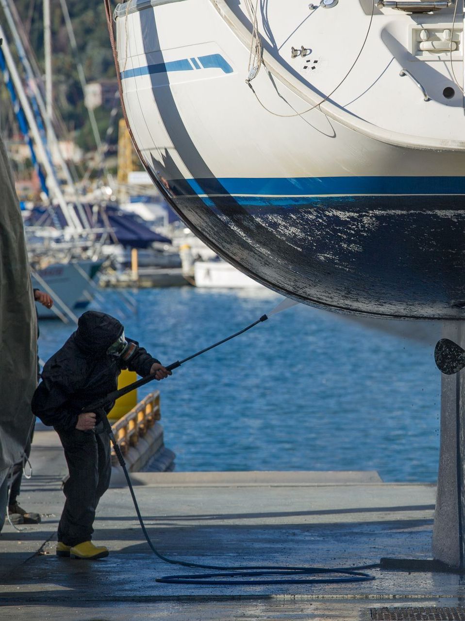 A man is washing a boat in the water