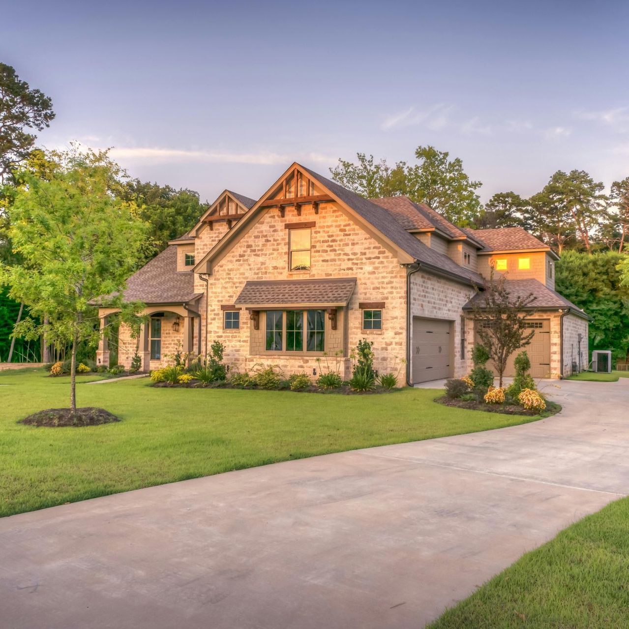 A large brick house with a driveway leading to it