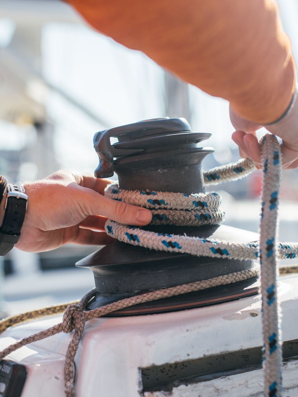 A close up of a person holding a rope on a boat