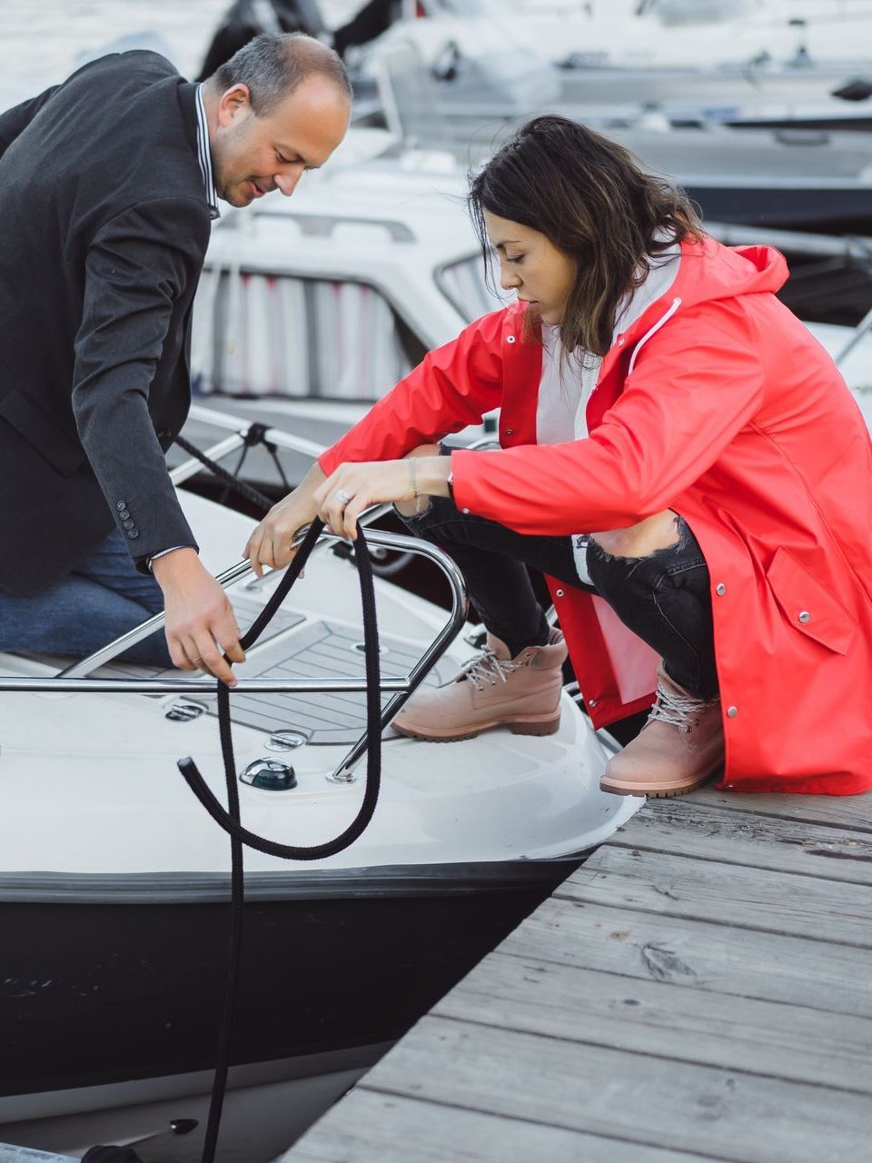 A man and a woman are working on a boat.