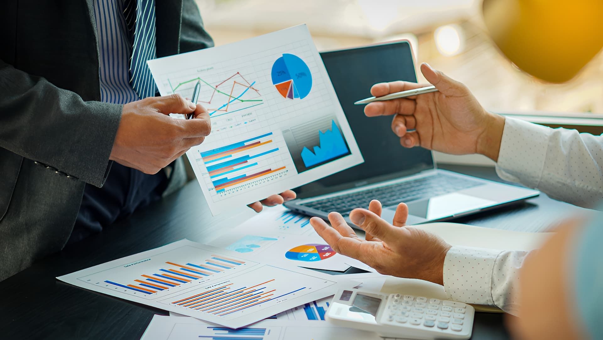 Two People Are Sitting At A Table Looking At A Piece Of Paper — BookSenz In East Maitland, NSW