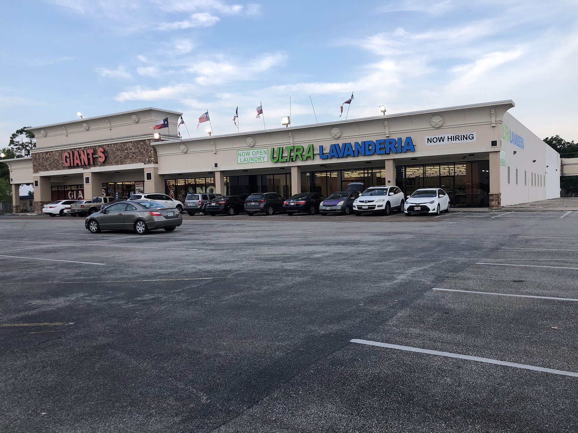 A funeral home with cars parked in front of it.