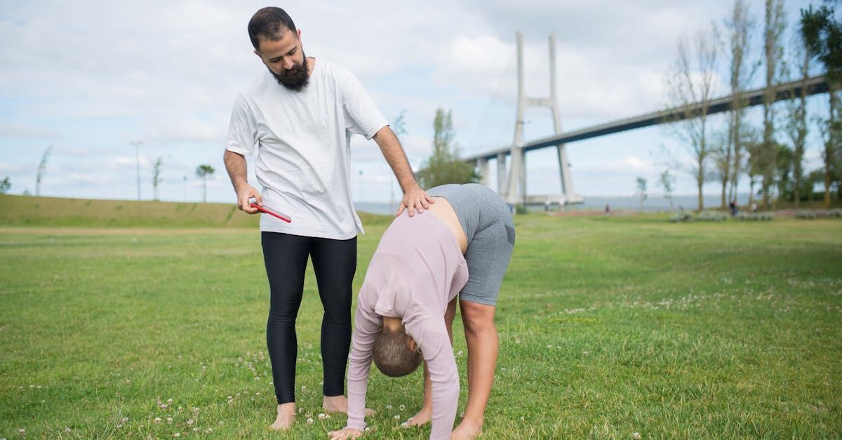 An older woman is practicing yoga in a greenhouse.