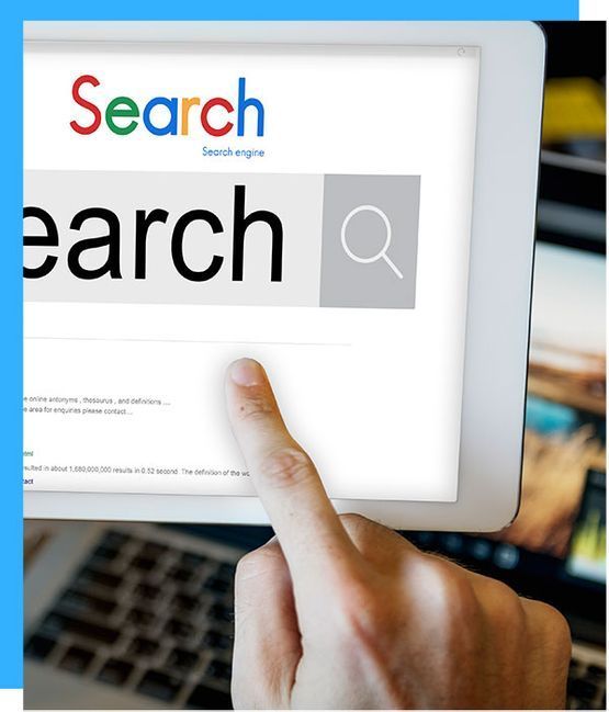 Hand touching a digital tablet screen, searching on a search engine; blurred computer background.