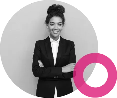 Woman in suit with arms crossed, smiling, in front of a light grey background, pink circle graphic.