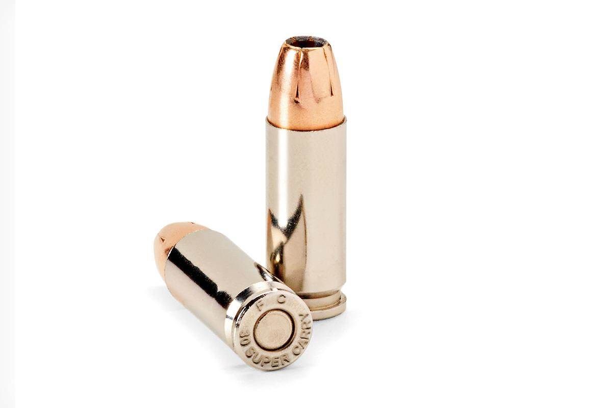 Two bullets are sitting on a white surface.
