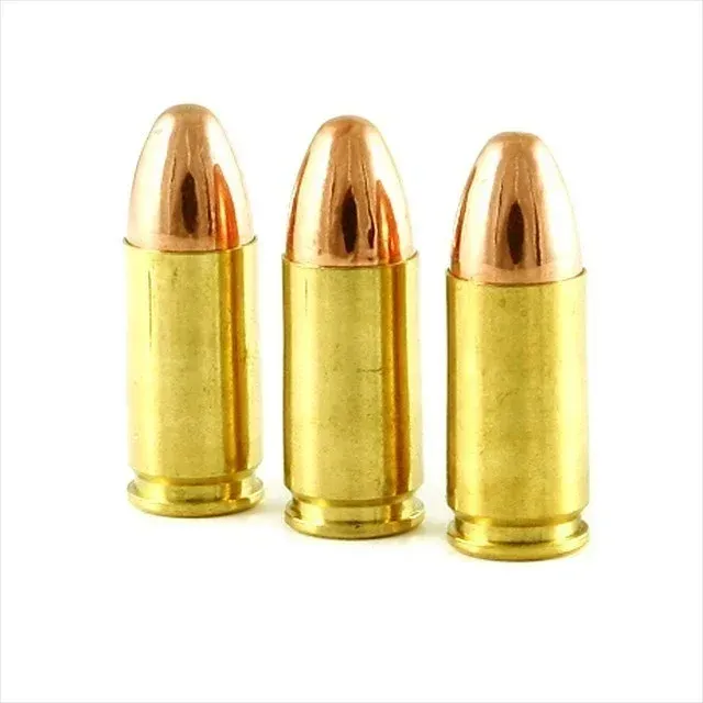 Three brass bullets with copper tops on a white background