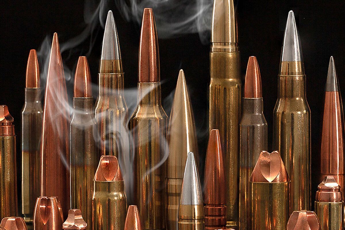 A bunch of different types of bullets with smoke coming out of them