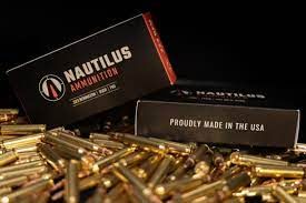 A box of nautilus ammunition is sitting on top of a pile of ammunition.