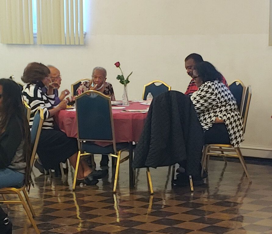 A group of people are sitting around a table in a room