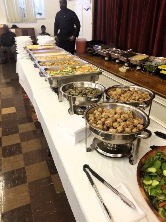A buffet table with a variety of food on it