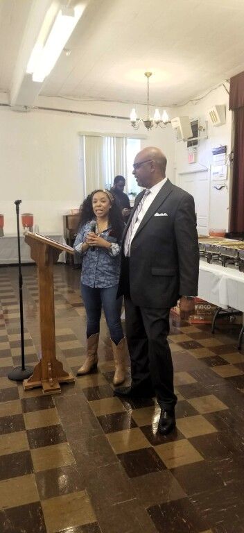 A man and a woman are standing next to each other in a room.