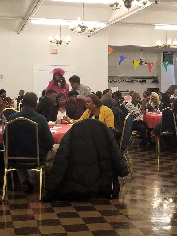 A group of people are sitting at tables in a room