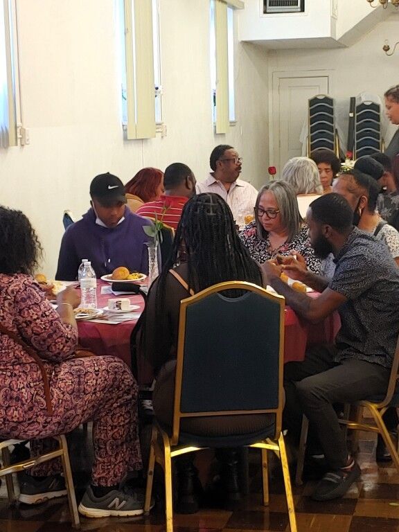 A group of people are sitting at tables in a room