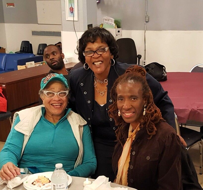 A group of people are posing for a picture at a table