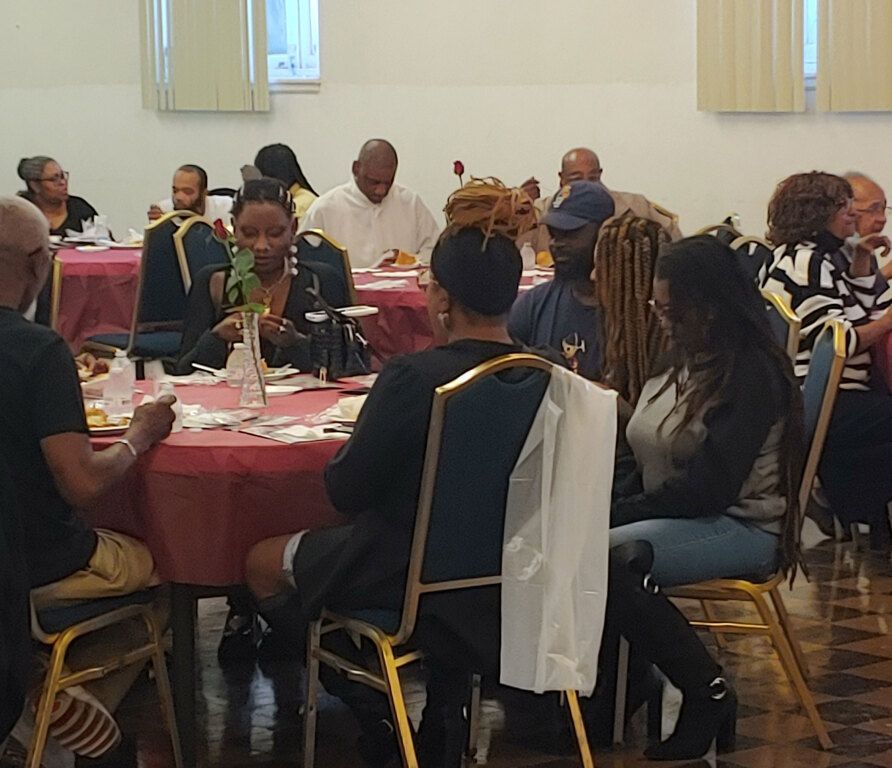 A group of people are sitting at tables in a room