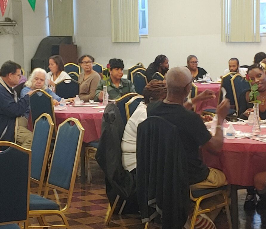 A group of people are sitting at tables in a room