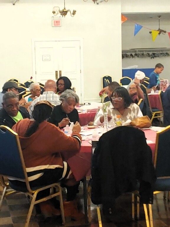 A group of people are sitting at tables in a room