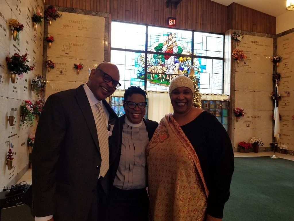 A group of people posing for a picture in a cemetery