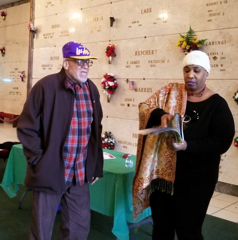 A man and a woman are standing in front of a wall that says recovery