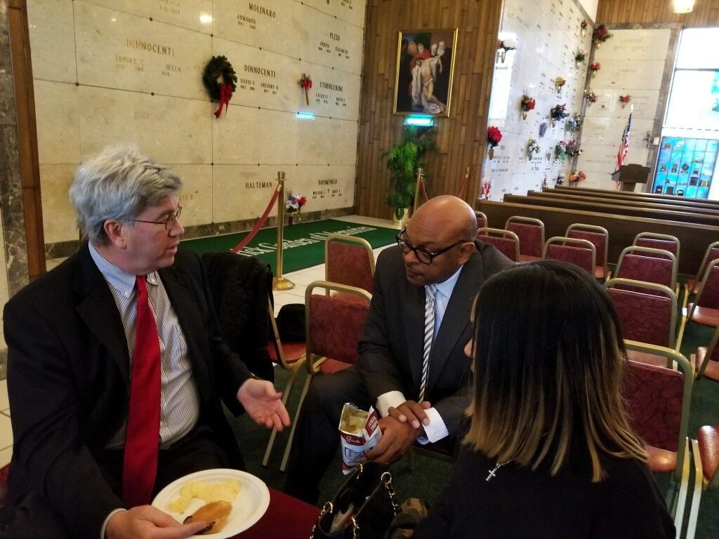 A group of people are sitting in a church talking