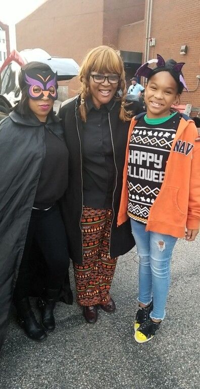 A group of people dressed in halloween costumes are posing for a picture.