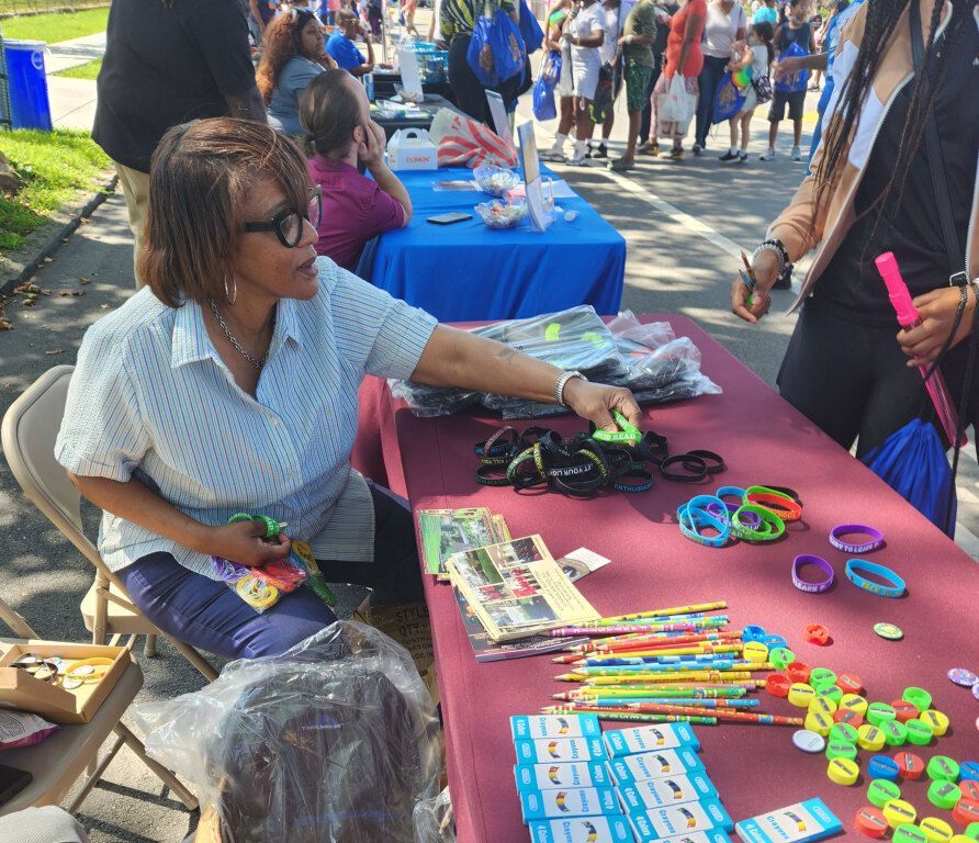 A woman sitting at a table with a bunch of toys on it