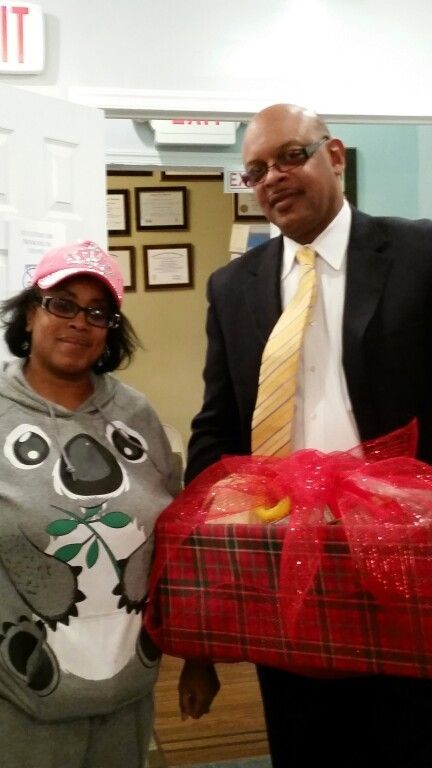 A man and a woman are standing next to each other in front of an exit sign