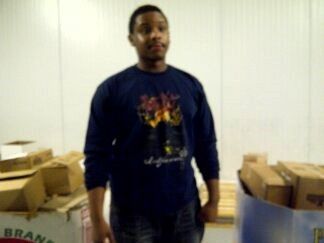 A man standing in front of a box that says brand