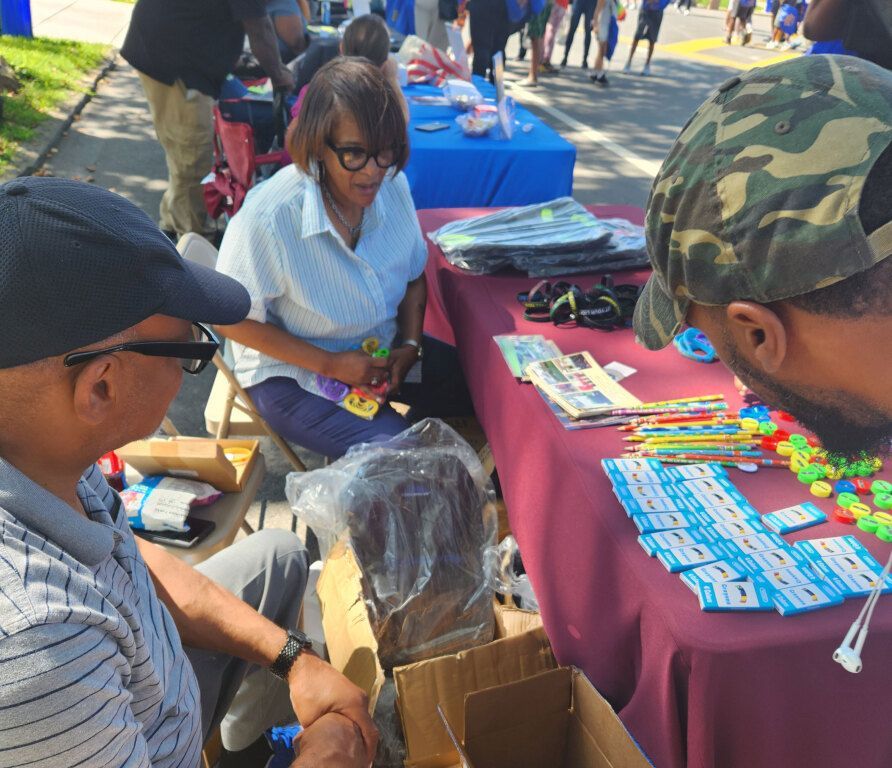 A man and a woman are sitting at a table looking at a box