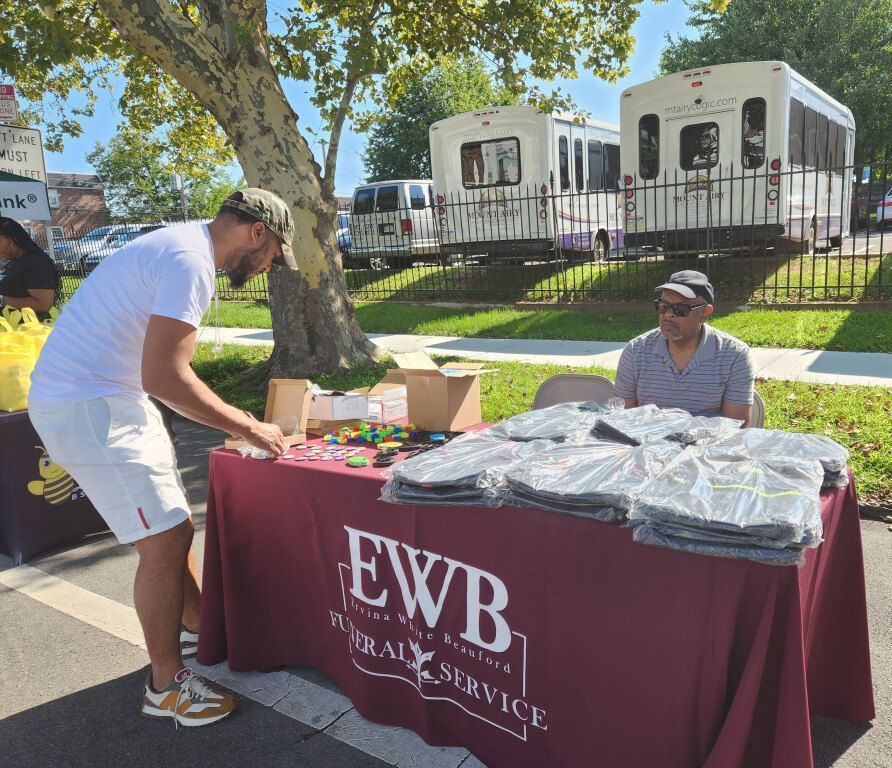 A man standing next to a table that says ewb on it