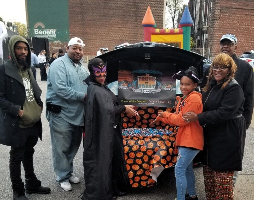 A group of people are posing for a picture in front of a bouncy house