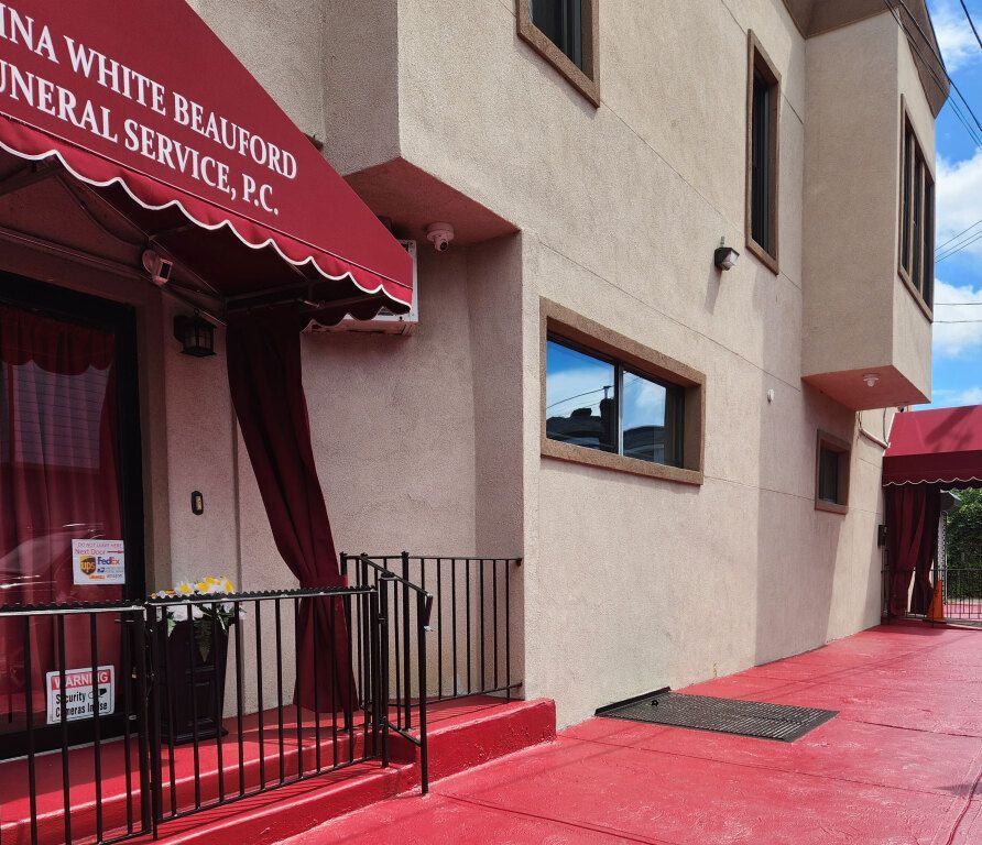 A building with a red awning that says funeral service p.c.