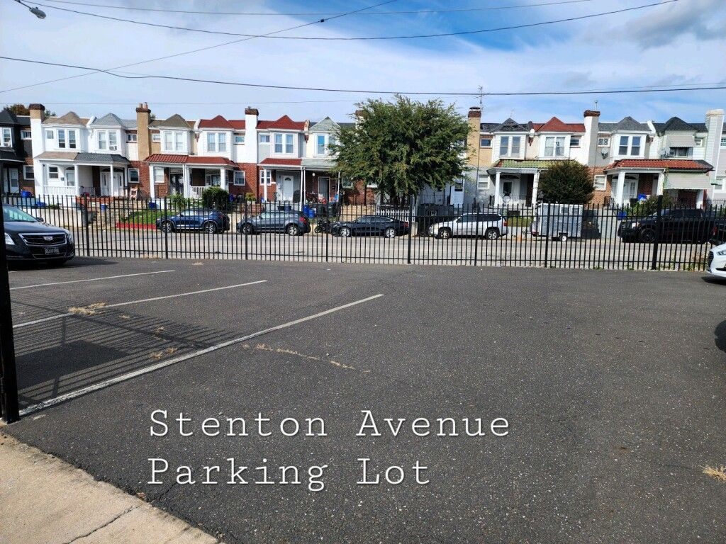 A parking lot on stenton avenue has cars parked in it